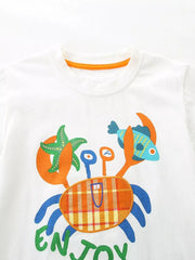 White cotton toddler t-shirt with playful crab graphic and orange trim.