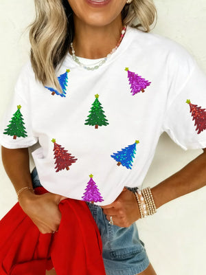 White t-shirt with scattered sequin Christmas trees in red, green, blue, and purple.