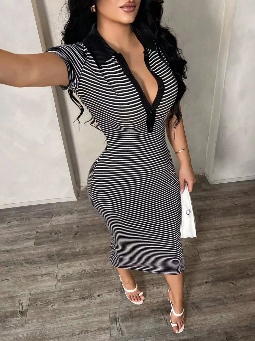 Black and white striped polo midi dress with button detail and short sleeves.