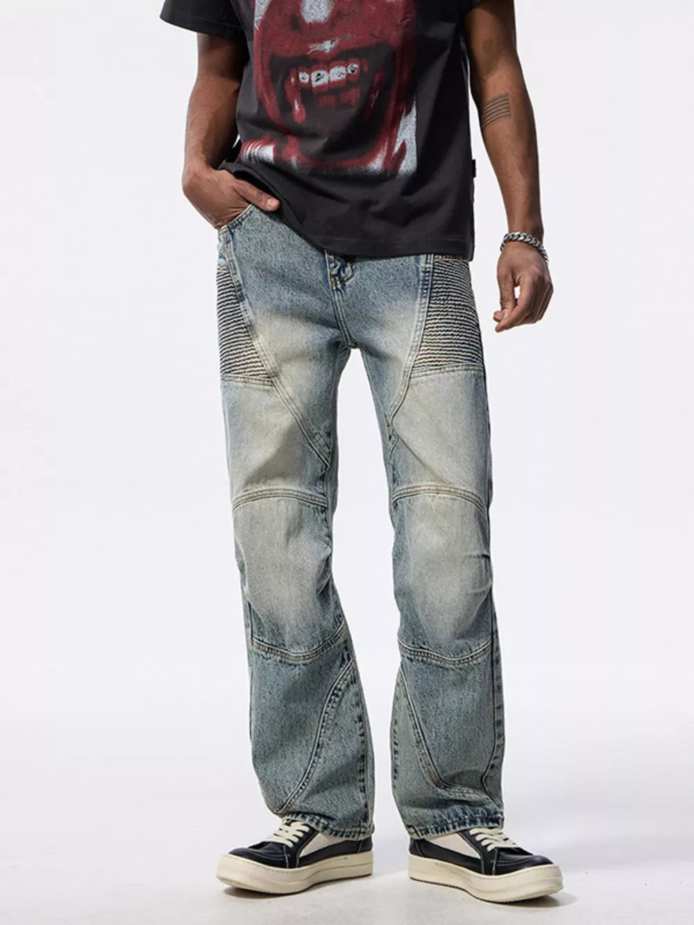 Men's light wash wide-leg moto jeans with ribbed panel details.