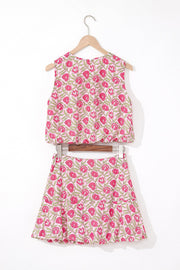 Floral print crop top and A-line skirt set in dusty pink with pink blooms and green leaves.