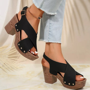 Black crisscross high heel sandals with stud details and adjustable ankle strap.