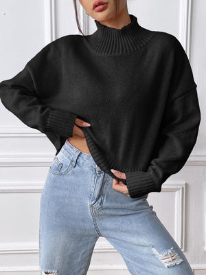 Black ribbed turtleneck cropped knit sweater with cuffed sleeves and hem.