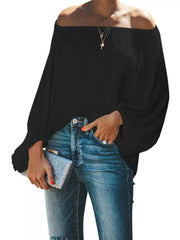 Black off-shoulder blouse with balloon sleeves and a ruffled neckline.