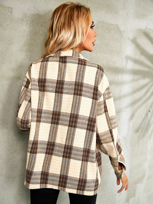 Collared jacket with a brown and tan plaid pattern, button front, and long sleeves.