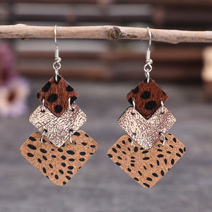 Textured leopard print drop earrings in tan and dark brown with layered diamond shapes.
