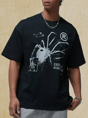 Black oversized graphic tee with spider, safety pins, and text print
