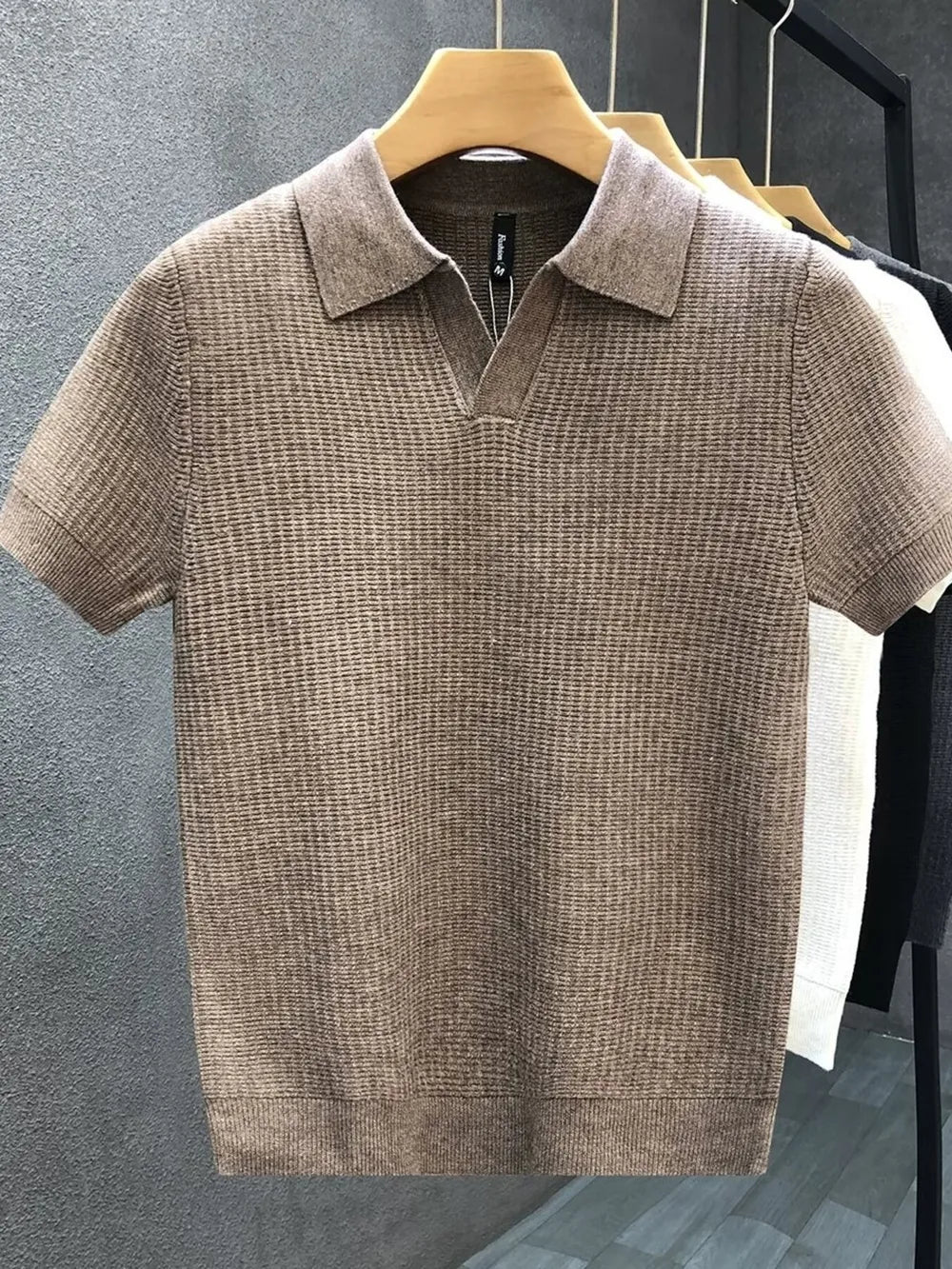 Brown textured knit slim fit polo shirt with short sleeves and a spread collar.