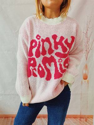 Pink knit jumper with pink "pinky rose" graphic, crew neck, and ribbed cuffs.