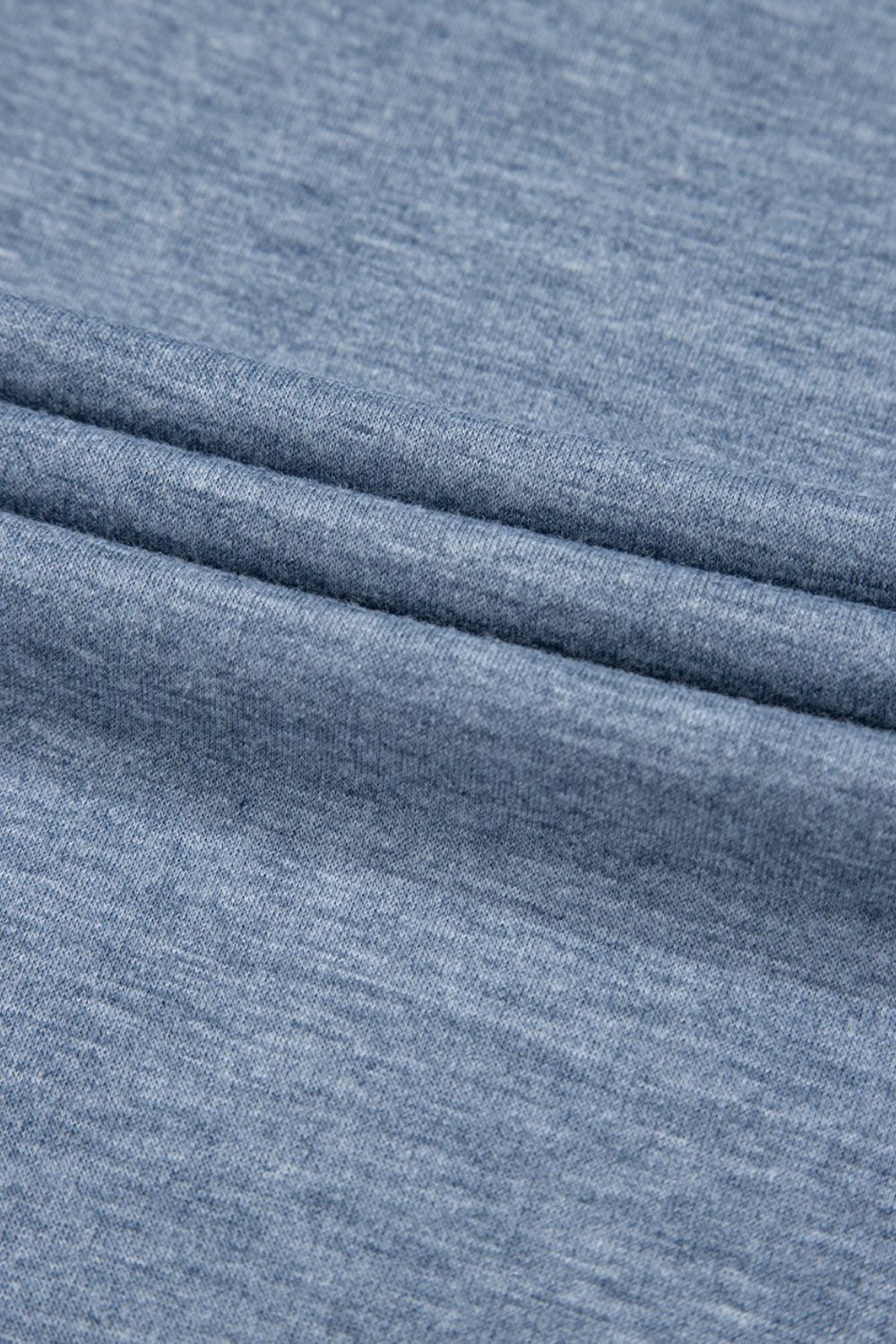 Denim-trimmed wide-leg utility jumpsuit in dusty blue heathered knit fabric.