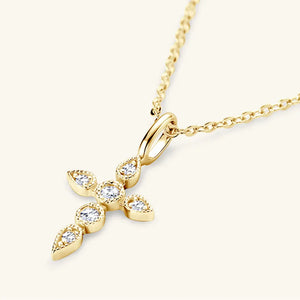 Gold cross pendant necklace with diamonds and delicate chain.