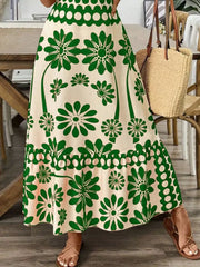 Charming floral midi dress in cream with green print, tie shoulders, and a-line cut.