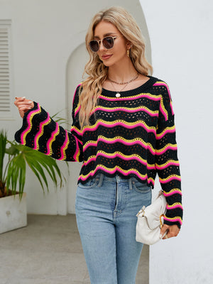 Black crochet crop sweater with pink and yellow wavy stripes, bell sleeves.