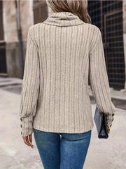 Ribbed cowl neck sweater in tan with button cuff details and long sleeves.