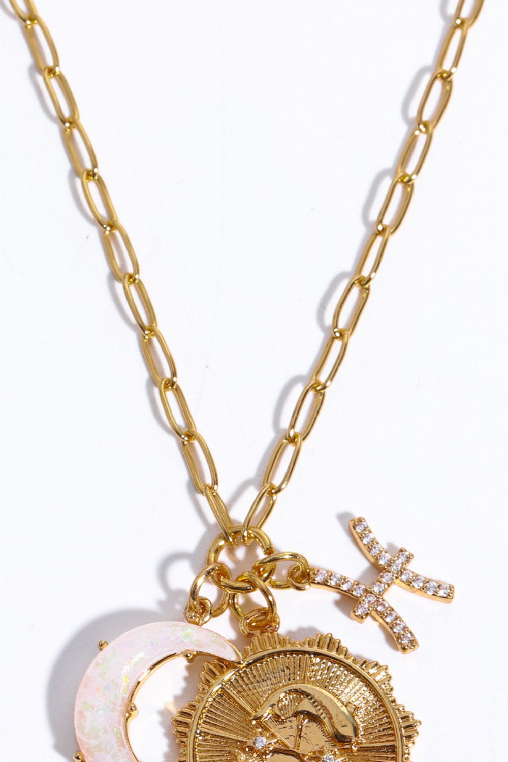 Gold celestial pendant necklace with zodiac symbols and moon charm.
