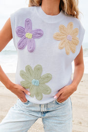 Sleeveless knit top in white with embroidered floral appliques in purple, yellow, and green.