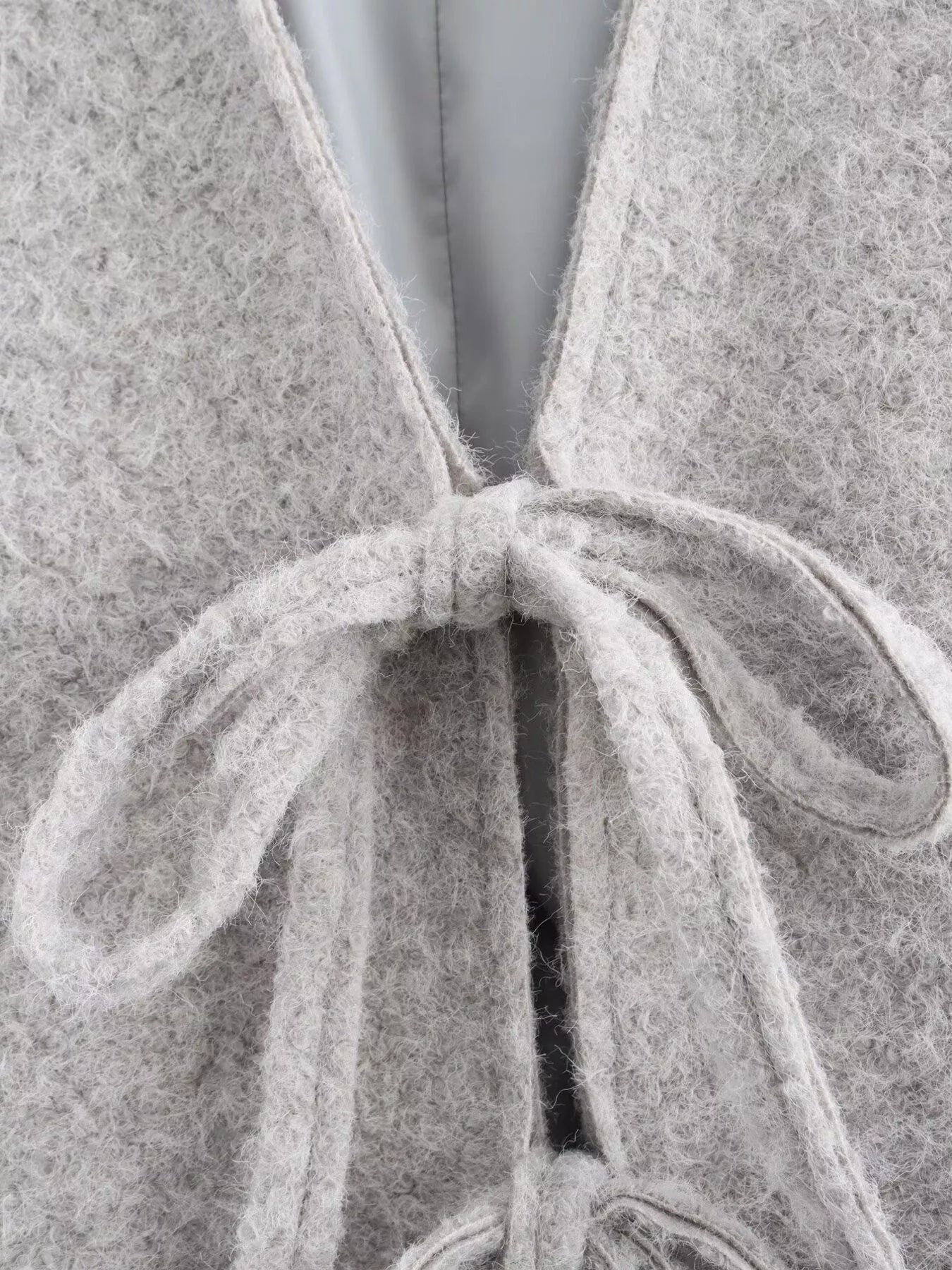 Silver gray textured knit tie-front cardigan with a fuzzy finish and tie detail.