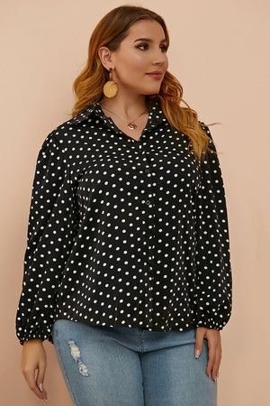 Black polka dot blouse with shirred balloon sleeves and a collared neckline.