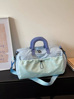 Light blue Oxford cloth travel bag with dual handles and front pouch