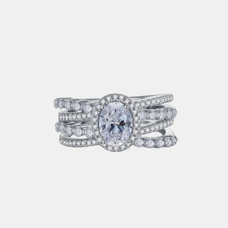 Triple band silver ring with oval moissanite center stone and halo.