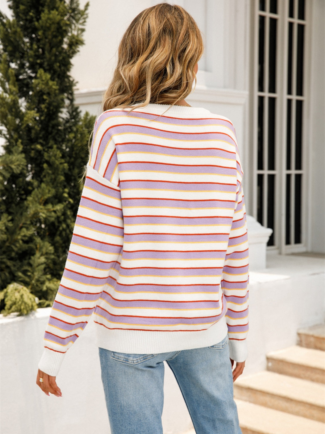 Pastel stripe crewneck knit sweater with lavender, white, red, and yellow stripes.