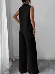 Black sleeveless collared top and wide-leg pants set with textured fabric.