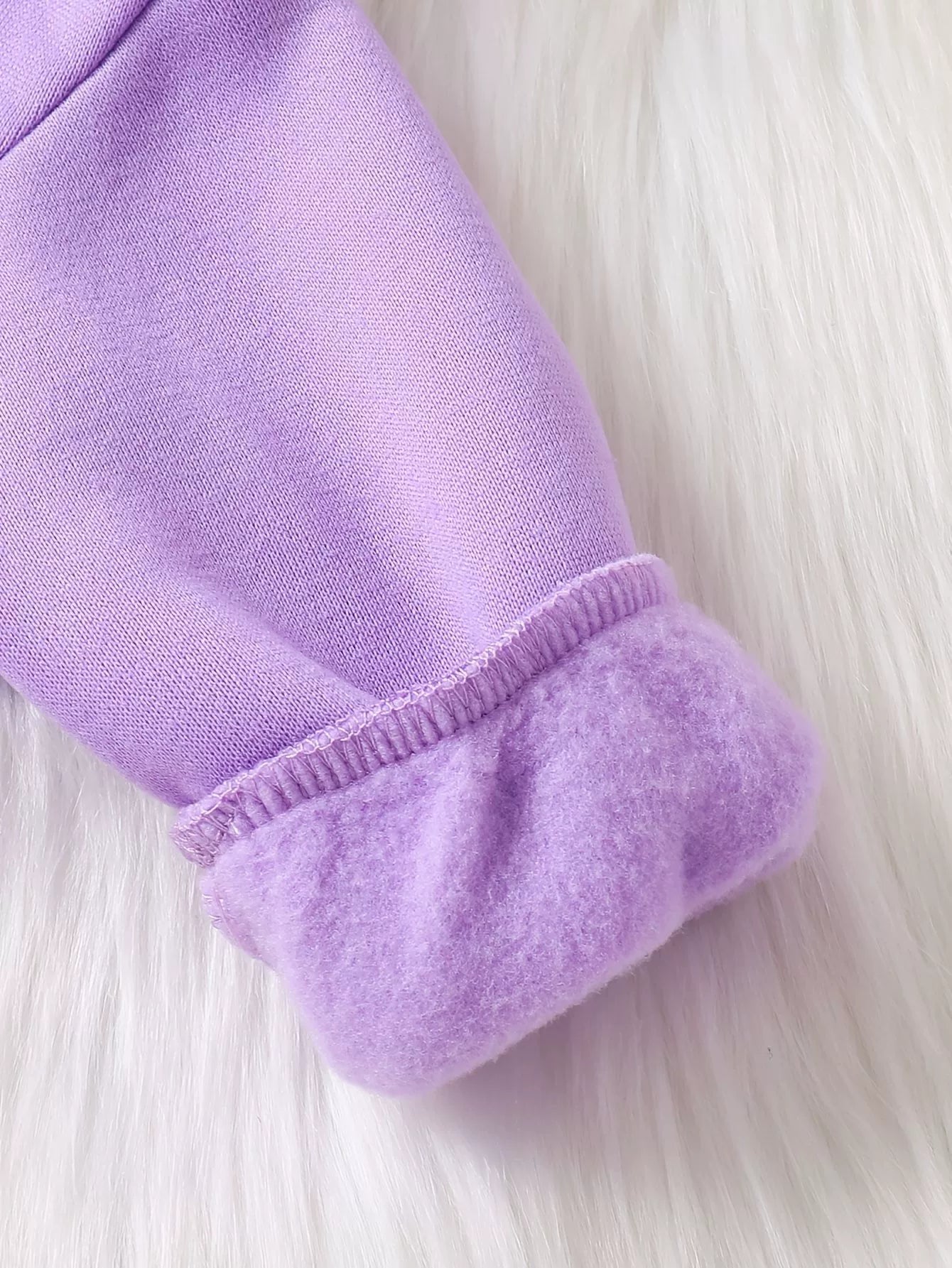 Lavender baby hoodie cuff with plush lining and stitched detail.