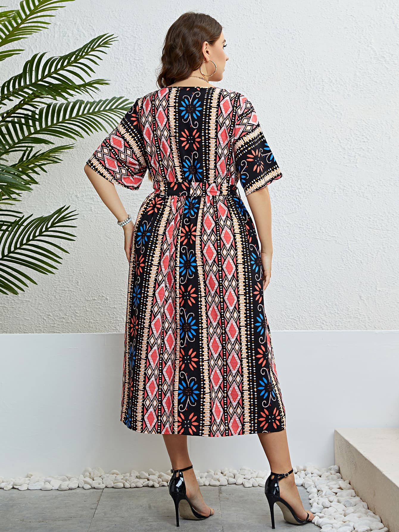 Multicolor geometric print midi dress with tie waist and short sleeves.
