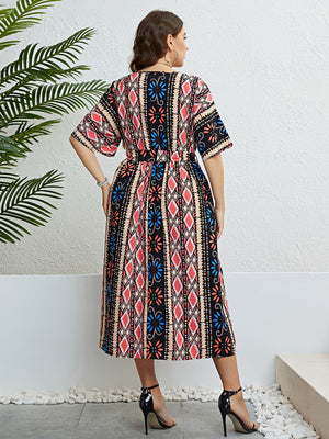 Multicolor geometric print midi dress with tie waist and short sleeves.