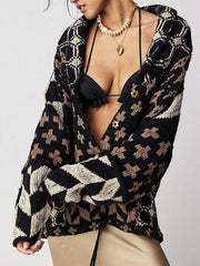 Geometric patchwork knit cardigan in black and tan with button front and drawstring waist.