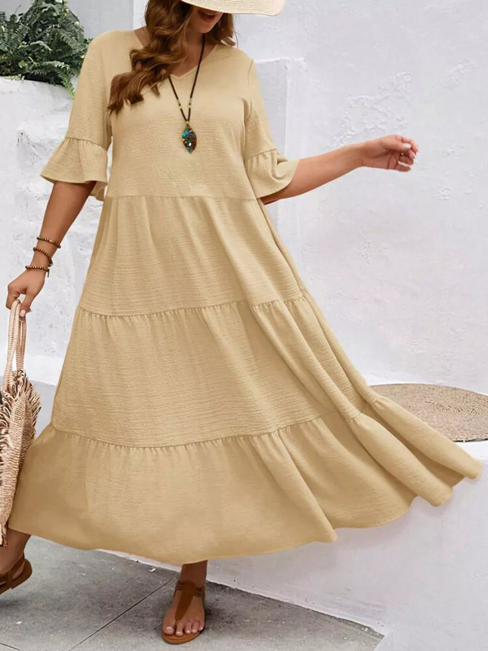 Apricot tiered midi dress with ruffle sleeves and crinkled texture.