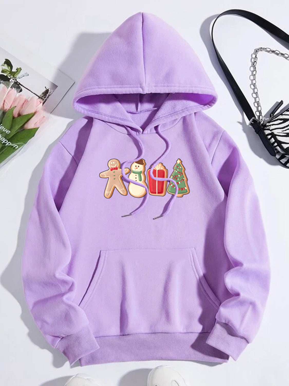 Heliotrope purple hoodie with gingerbread man, snowman, gift, and Christmas tree graphic.