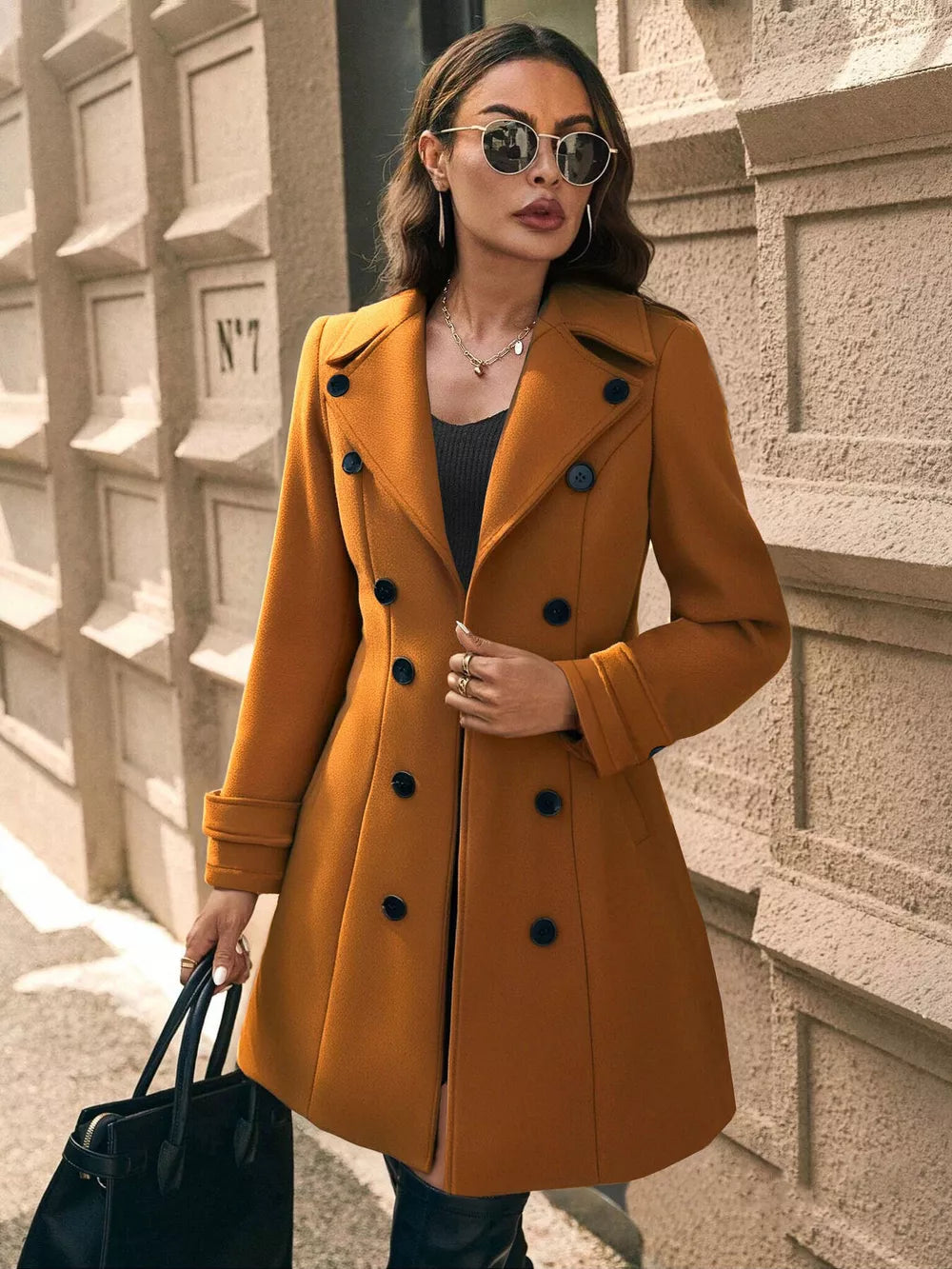 Caramel double-breasted wool blend trench coat with button details and cuffed sleeves.