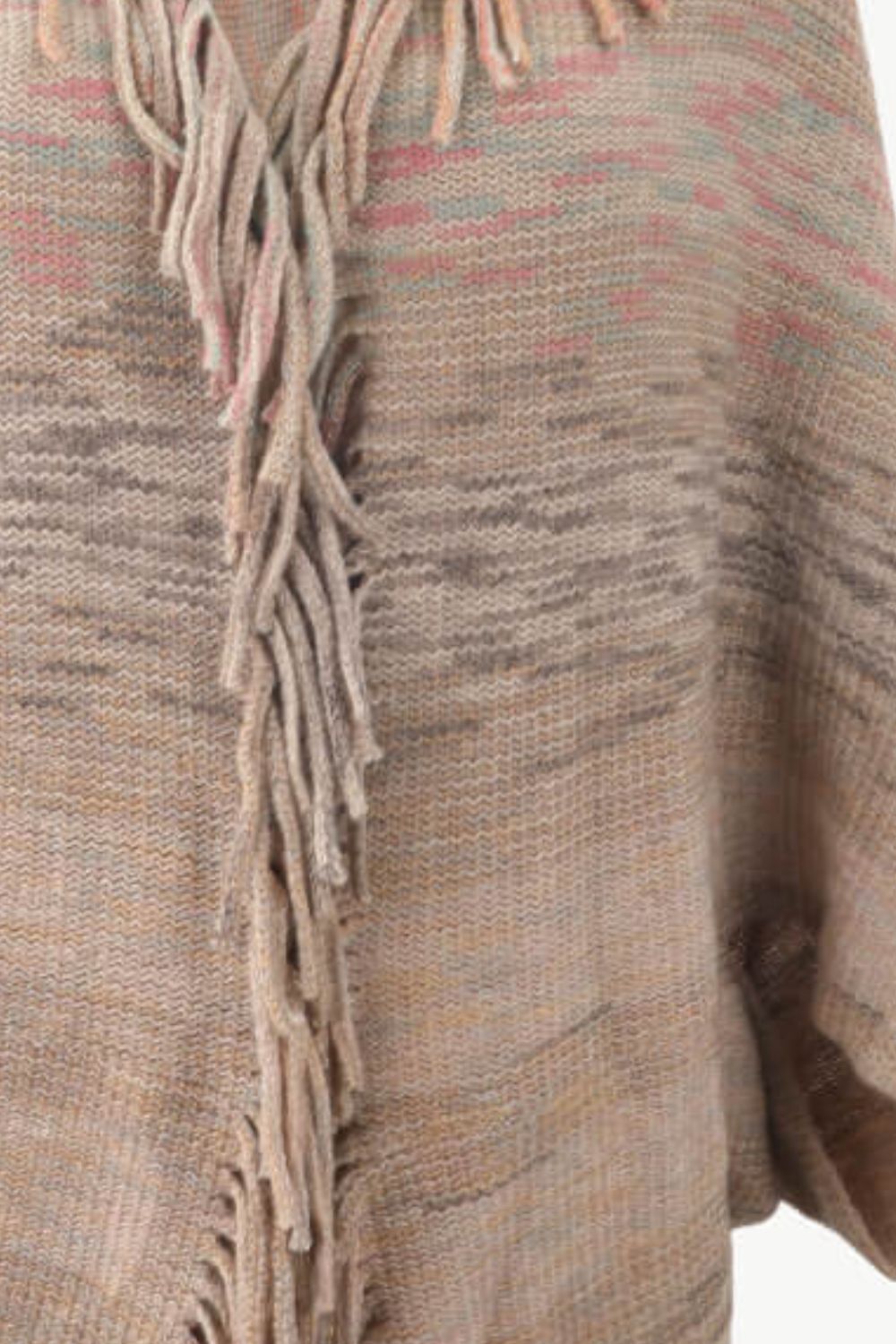 Textured stripe knit cape in tan with fringe detail and subtle blush pink accents.