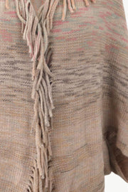 Textured stripe knit cape in tan with fringe detail and subtle blush pink accents.