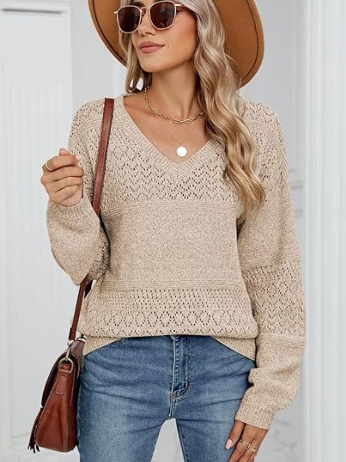 Tan eyelet stitch V-neck pullover sweater with long sleeves and textured detail.
