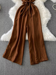 Brown V-neck wide leg jumpsuit with tie waist and button details