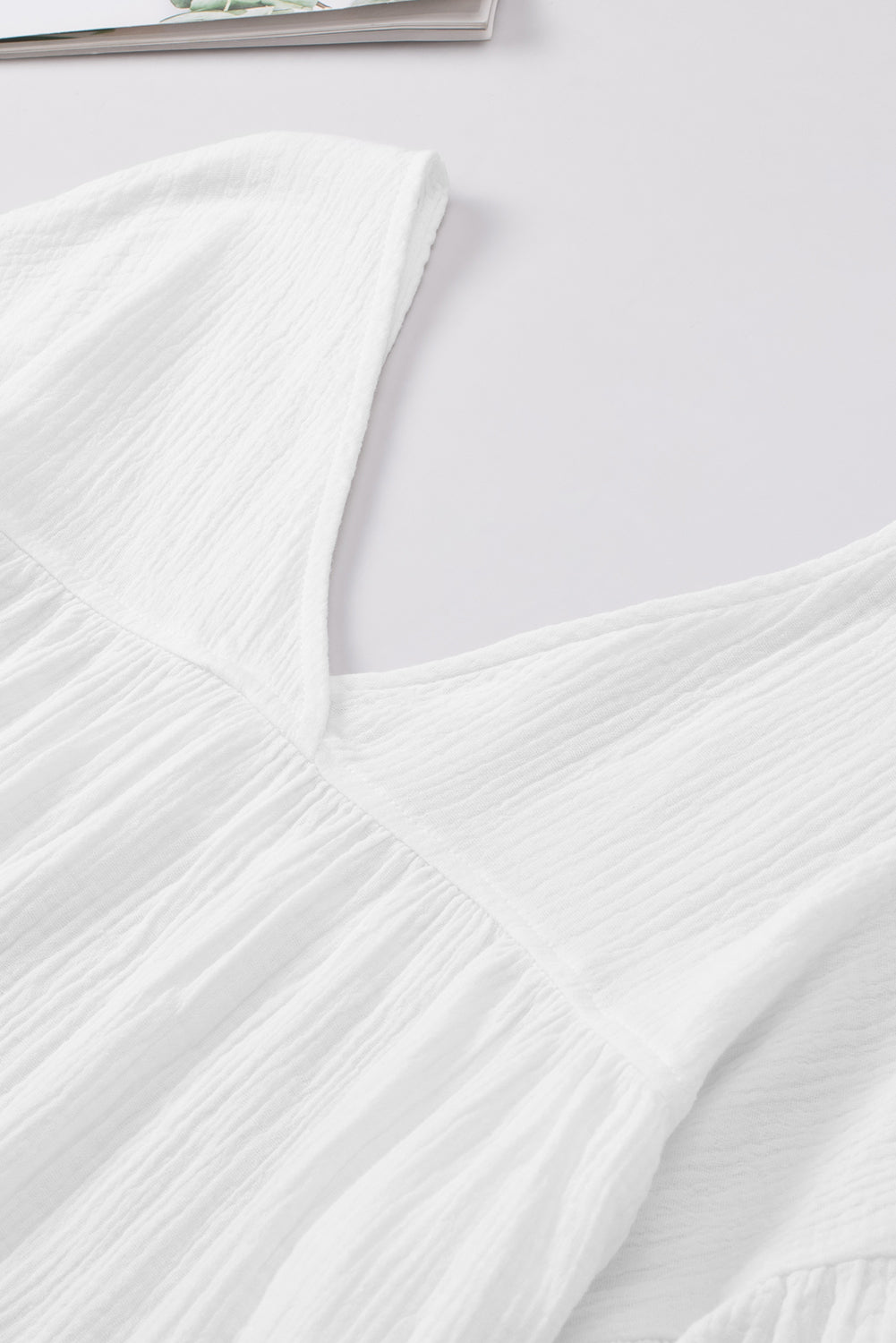 White textured gauze blouse with V-neck and gathered detail