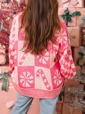 Candy Cane Checkered Knit Sweater in Blush Pink with candy cane and peppermint designs.