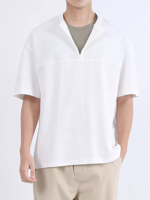 White cotton half-zip t-shirt with short sleeves and a boxy fit.
