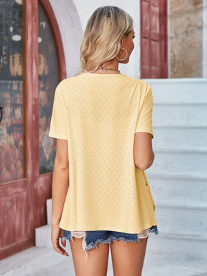 Light yellow perforated shawl collar jacket with short sleeves.