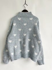 Mint blue acrylic turtleneck sweater with allover white heart motif and textured knit.