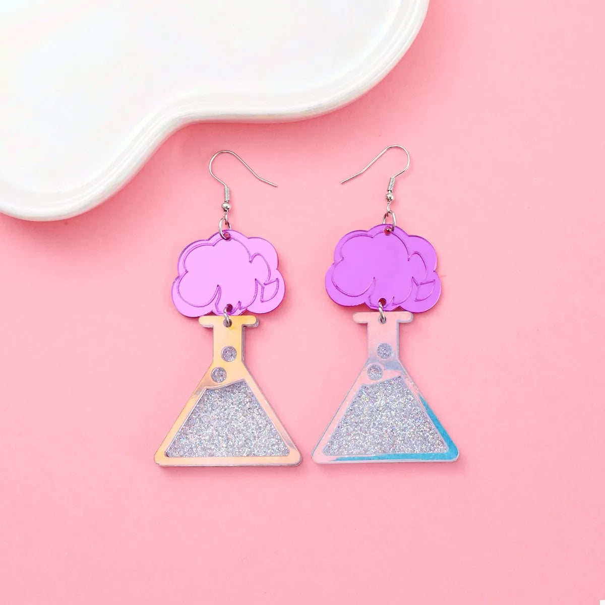 Funky science beaker dangle earrings in fuchsia pink acrylic with glitter accents.