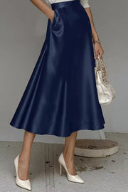 Navy a-line midi skirt with hidden pockets and a lustrous finish.