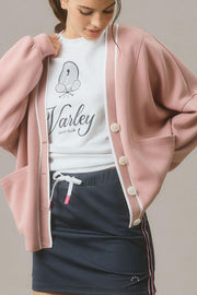 Dusty pink buttoned cocoon cardigan with varsity trim.