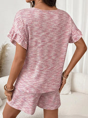 Pink ruffled sleeve two-piece set with textured shorts and top.