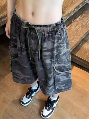 Relaxed fit black camo cargo shorts with drawstring waist and cargo pockets.