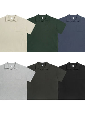 Boxy knit polo shirt with patch pocket in beige, dark green, dusty blue, gray, dark gray, and black.