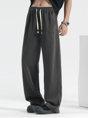 Men's grey casual drawstring sweatpants with embroidered logo detail