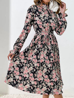 Black floral midi dress with pleated skirt and tie waist.